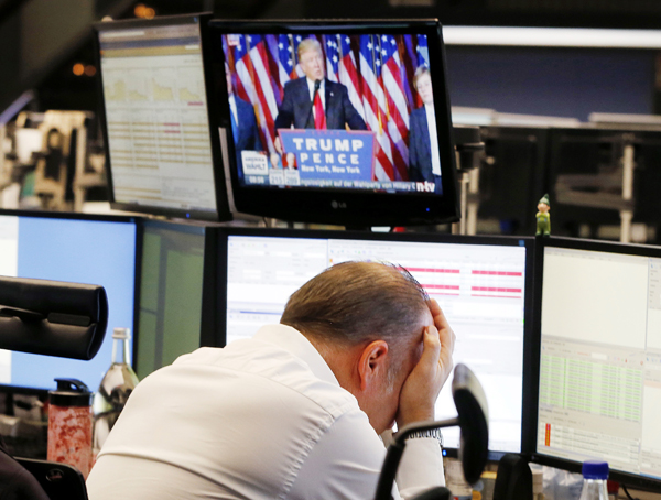 A broker reacts as President-elect Donald Trump shows up on a television screen at the stock market in Frankfurt, Germany, on Wednesday (AP photo)